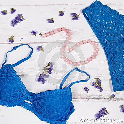 Blue lacy lingerie set with pearl necklace and nude shoes Stock Photo