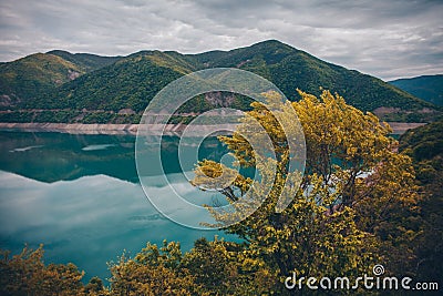 Blue lake and yellow bush in mountains Stock Photo