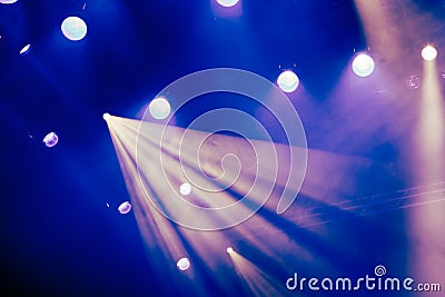 Blue light rays from the spotlight through the smoke at the theater or concert hall. Lighting equipment for a performance or show Stock Photo