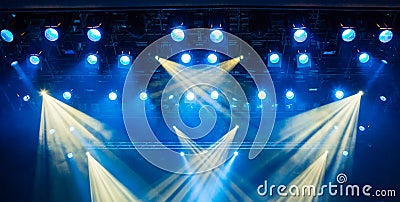Blue light rays from the spotlight through the smoke at the theater or concert hall. Lighting equipment for a performance or show Stock Photo