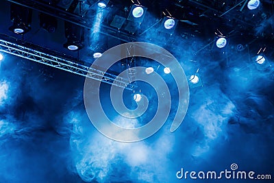 Blue light rays from the spotlight through the smoke at the theater or concert hall. Lighting equipment for a performance or show Stock Photo