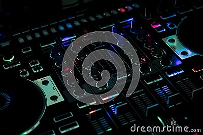 Blue light spots on DJ Controller in Club night all in one controller Stock Photo