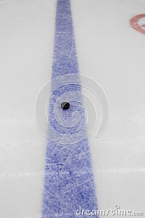 Blue line with puck on ice hockey rink Stock Photo