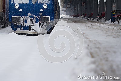 Blue locomotive train in railway station in winter time Stock Photo