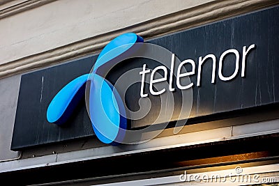 The blue logo of the Telenor telecommunication company at the store in Swedish Stockholm Editorial Stock Photo