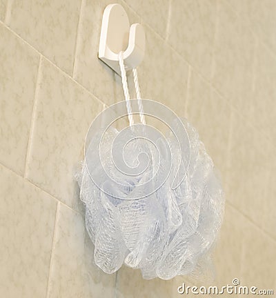 Blue loofa hanging in shower Stock Photo