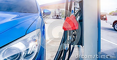 Blue luxury SUV car fueling at gas station. Refuel fill up with petrol gasoline. Petrol pump filling fuel nozzle in gas station. Stock Photo