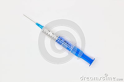 Blue medical disposable syringe for injection on a white background. Medical instrument for vaccination. 10 ml syringe for COVID Stock Photo