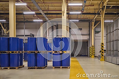 Chemical industry, paint and varnish production . Metal barrels for chemicals. Barrels are stored in a warehouse Stock Photo