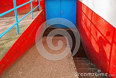 Blue metallic door as entrance to a building basement Stock Photo