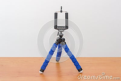 Blue mini flexible tripod for smartphones. Tripod for phone Stock Photo