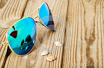 Blue mirrored sunglasses wiht reflection of martini glass on the Stock Photo