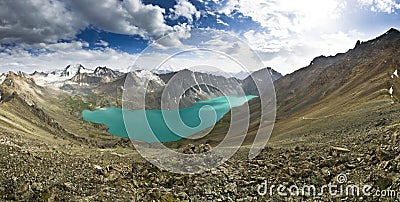 Blue mountain lake surrounded by high peaks at sunset Stock Photo