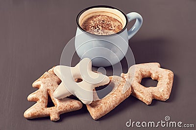 Blue mug of coffee with foam near cookies of different shapes on concrete surface Stock Photo