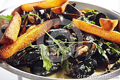 Blue Mussels in Cream Sauce with Spicy French Baguette Stock Photo