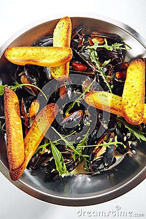 Blue Mussels in Cream Sauce with Spicy French Baguette Stock Photo