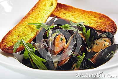 Blue Mussels in Cream Sauce with Spicy French Baguette Stock Photo