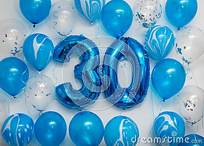 Blue number 30 celebration foil balloons with helium balloons on white background. Party decoration for happy birthday celebration Stock Photo