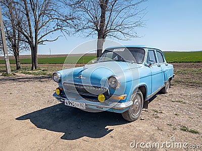 Blue old soviet car GAZ M21 Volga / GAZ-21 oldtimer parked on the road in spring sunny weather Editorial Stock Photo