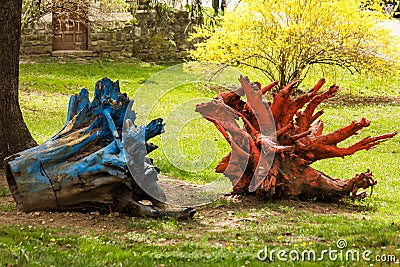 Blue and orange painted stumps in Dimitrie Ghica park Stock Photo