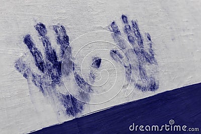 Blue painted hand print on white wall. Human hand, palm, fingers Stock Photo