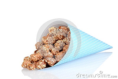 Blue paper cone of honey sesame seed almonds Stock Photo