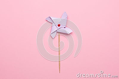 Blue paper windmill pinwheel isolated on pink background, Circus, Childhood, Festival, Party, Fun, joy, Happines Stock Photo