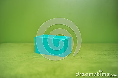 Blue parallelepiped on a green background, Stock Photo