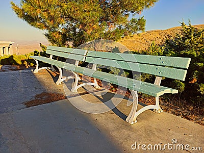 Blue Park bench in summer at sunset Stock Photo