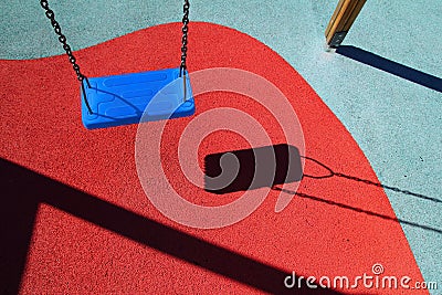 Blue park swing or red floor children playground Stock Photo