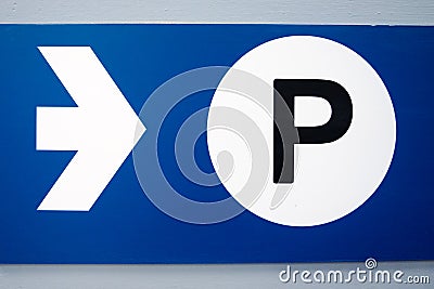 Blue parking sign with white arrow and black capital P on white background Stock Photo