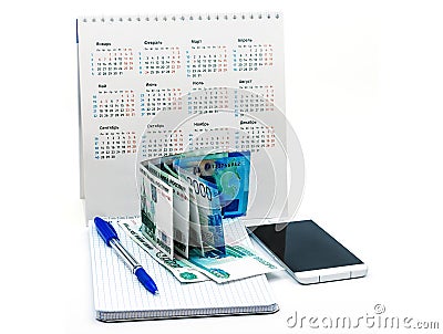 Blue pen and Notepad on a white background, phone and money, Russian money and calendar Stock Photo