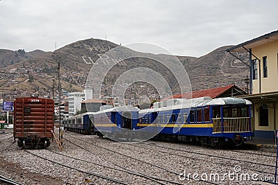 Blue Perurail Train carriages standing in Cusco Station with 
