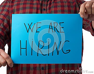 Blue piece of paper with the inscription we are hiring, concept of unemployment against the backdrop of the global crisis Stock Photo