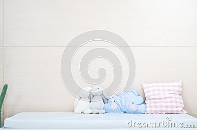 Blue pillow, cute rabbit doll in bed in the bedroom Stock Photo