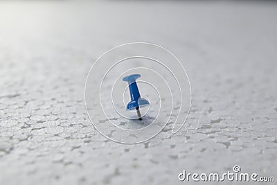 Plug the pin in the white cork Stock Photo