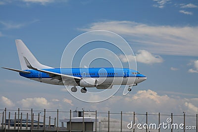 Blue plane approaching runway Stock Photo