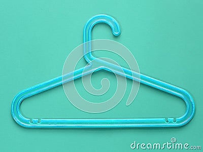 Blue plastic cloth hanger on blue background Stock Photo