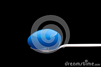 Blue plastic Easter Egg on a white spoon Stock Photo