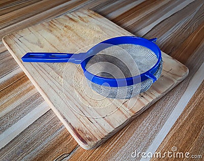 A Blue plastic sieve with silver mesh Stock Photo