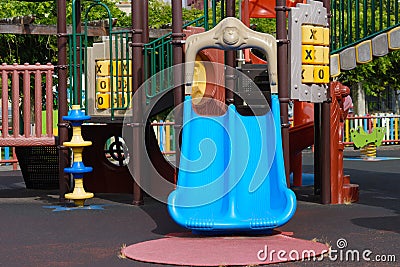 Plastic slide on empty multicolored playground Stock Photo