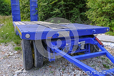 Blue platform trailer truck close-up. Transportation equipment. Logistics element. Heavy machinery Stock Photo