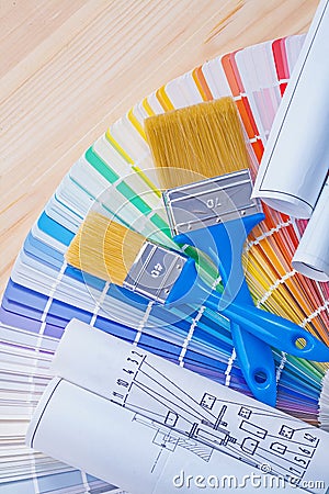 Blue prints and paintbrushes on opened color Stock Photo