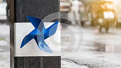 A blue propeller stuck on a light pole and it rains during Stock Photo