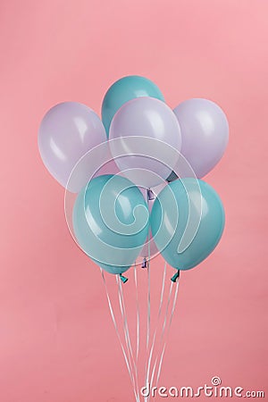 Blue and purple festive balloons on pink background. Stock Photo