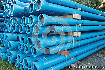 Blue PVC plastic pipes and fittings used for underground water supply and sewer lines Stock Photo