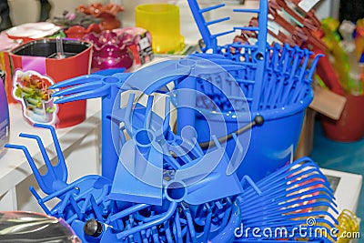 Blue rake Plastic products, plant care products in a supermarket display case. Recycled plastic Stock Photo