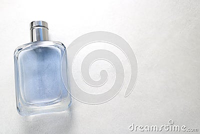 Blue rectangular beautiful glass transparent shiny fashionable glamorous bottle of cologne, perfume with silvery bezel and place f Stock Photo