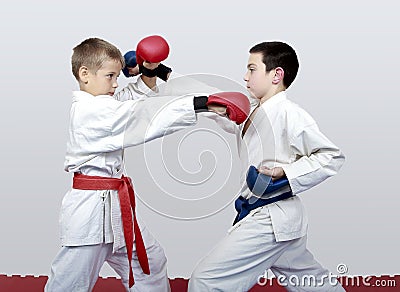 With blue and red belt boys train paired exercises karate Stock Photo