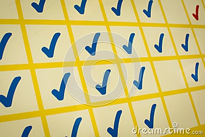 Blue and red checkmarks in yellow grid Stock Photo